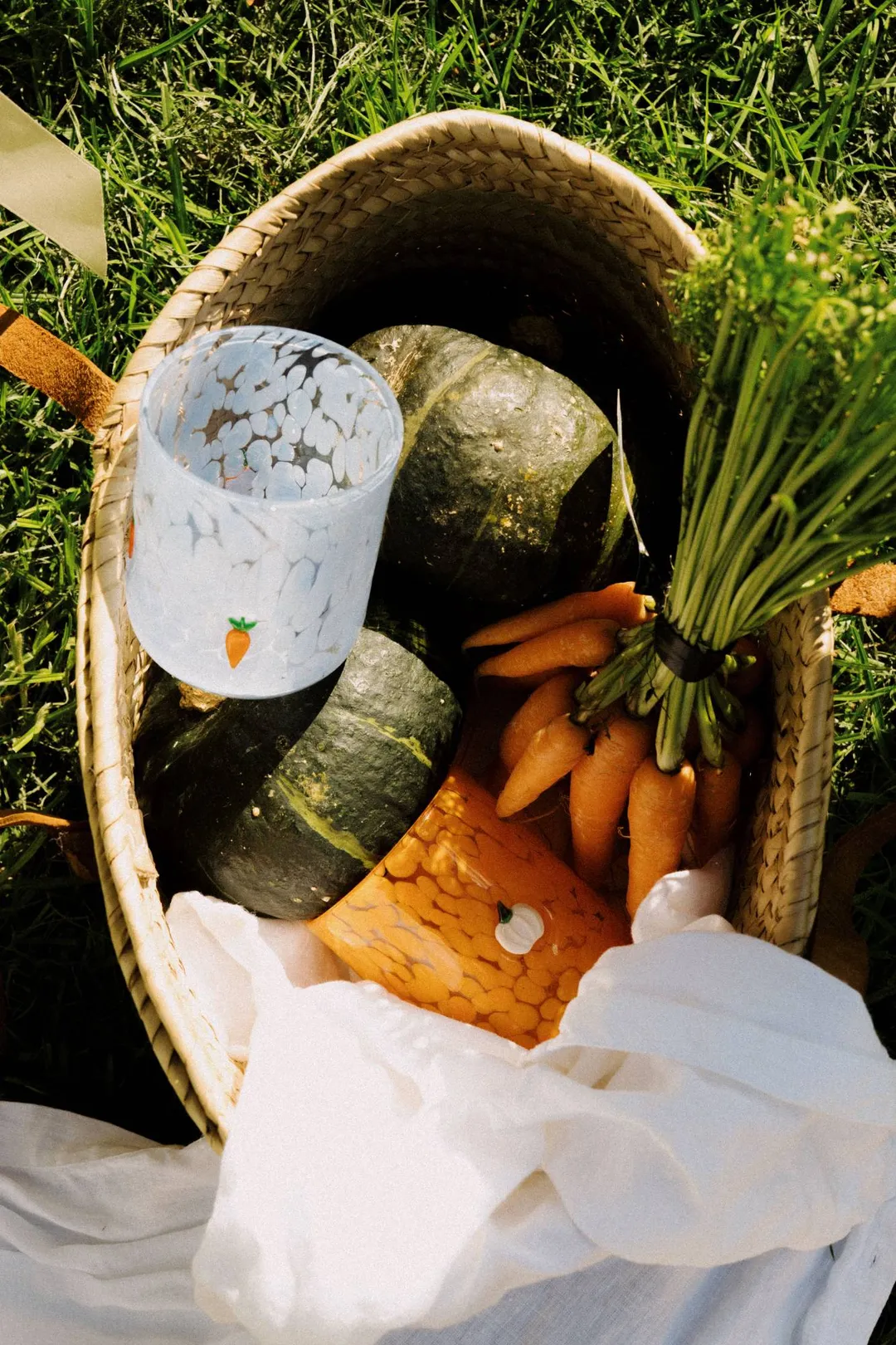 Pumpkin and Carrot Speckle Icon Cups in a woven basket with pumpkins and carrots