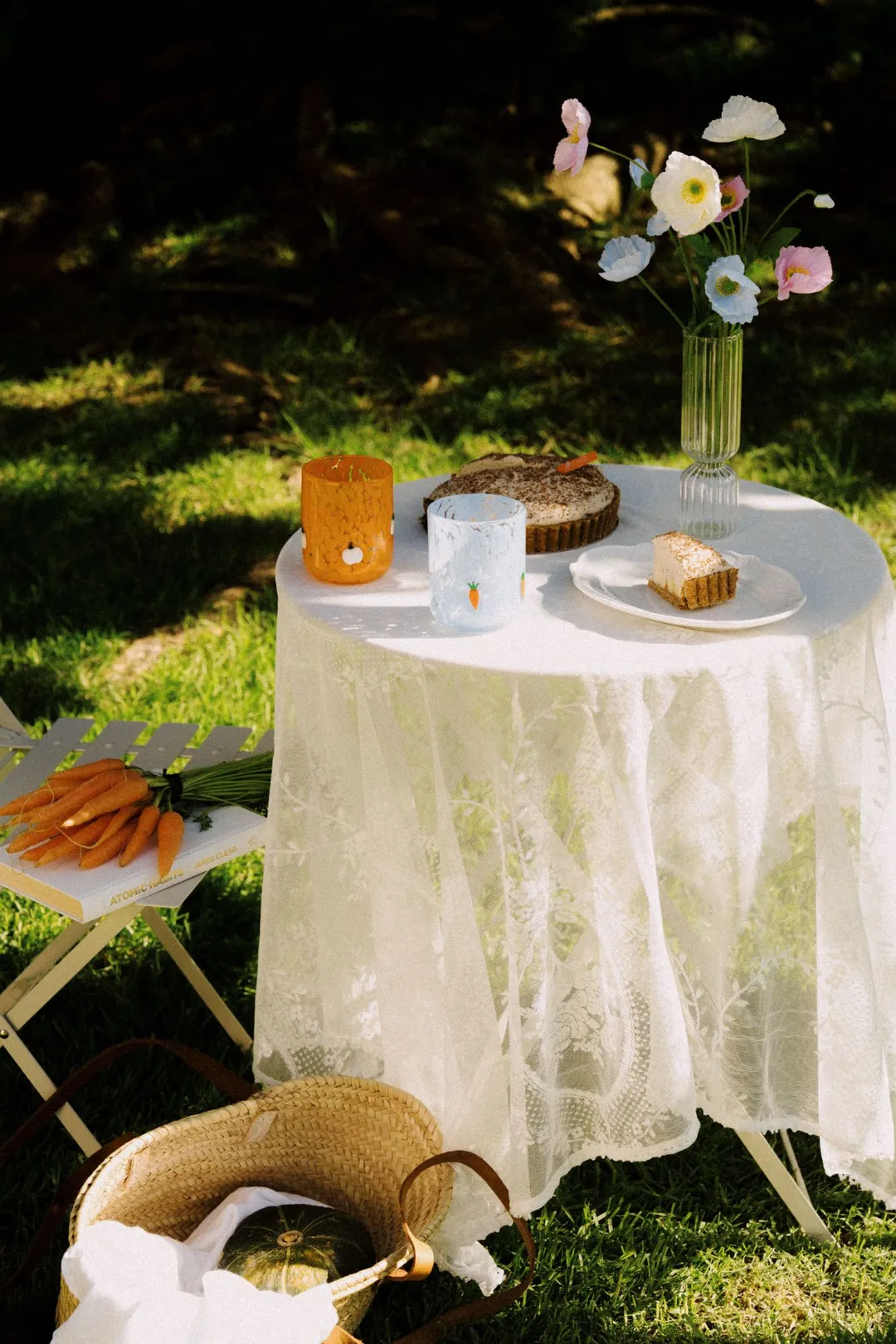 Speckle Icon Cups in Pumpkin and Carrot on a lace-covered garden table with pie and poppies
